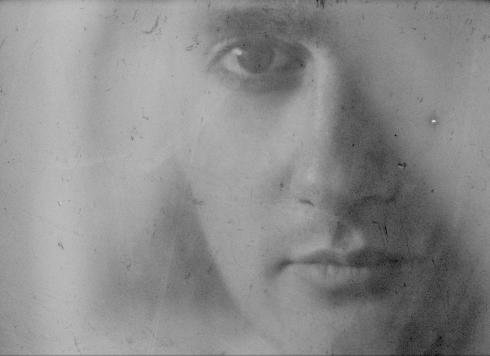 Dreamy, black and white, analog closeup of a man’s face shot with 16mm film.